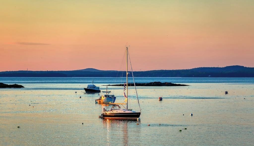 A calm harbor with boats and a clear sky.