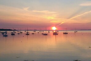 A calm body of water with multiple boats anchored, a clear sky, and a visible horizon line. - Dog-friendly home 1 block from beach with firepit, amazing ocean views, & office (Rockland)