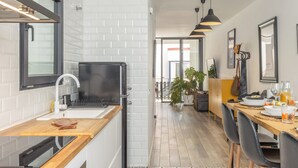 Een moderne keuken met een ingebouwde oven, een spoelbak en een houten aanrecht.
