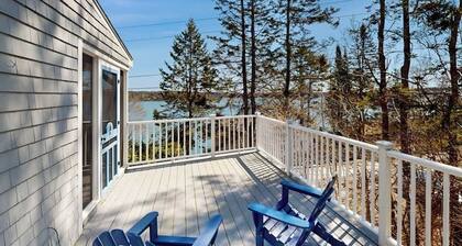 Dog-friendly river-view home with wood stove, deck, patio, dock, beach, grill