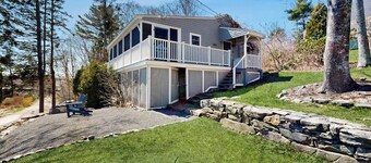 Dog-friendly river-view home with wood stove, deck, patio, dock, beach, grill