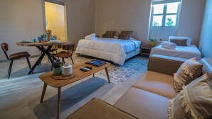A bedroom with a bed, a sofa, a table, and a chair. - Apt. Suite with pool in colonial house  Downtown (Santa Marta)