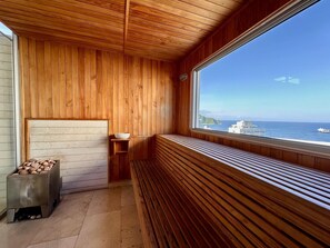 A wooden interior with a bench, a bowl, and a container of stones. - Modern Ocean View Apartment | Grand Marina (Santa Marta)