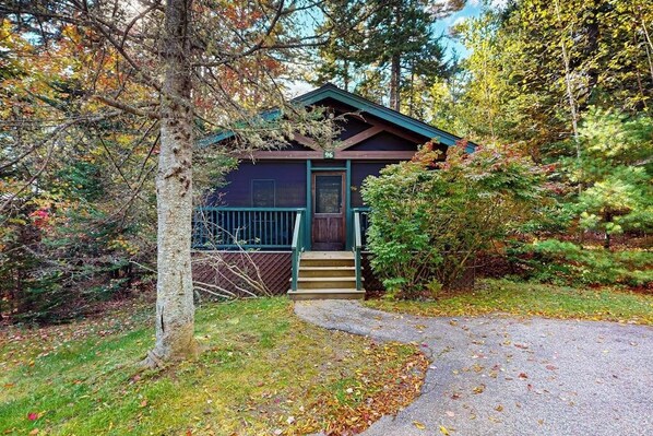 A cabin with a porch, a door, and a number '96' on the front.