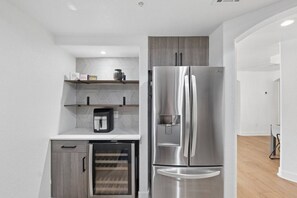 A compact kitchen with a built-in coffee maker, a mini-fridge, and a stainless steel refrigerator. - Scottsdale Pad Steps to Kierland | Pool | Spa (Scottsdale)