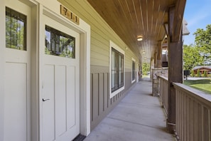 A covered corridor with doors marked '711' and a stone pillar.