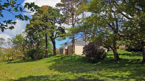 A house surrounded by trees and grass. - 4 Bed in Renvyle (oc-i258) (Illaunroe)