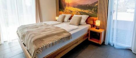 A bed with a wooden frame, a headboard, and a nightstand with a lamp.