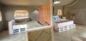A bedroom with two beds, a large window, and a ceiling fan. - Gal Oya Lodge (MADULLA)