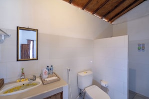 A bathroom with a sink, mirror, toilet, and shower area. - Sunrise Penida Hill by ABM (Penida Island)