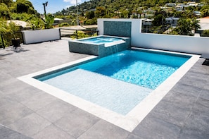 A rectangular swimming pool with a tiled edge, surrounded by a grey tiled deck. - -20% Maravillas 1BR Condo near Beach and Port-of-Spain (With Pool) (Port of Spain)