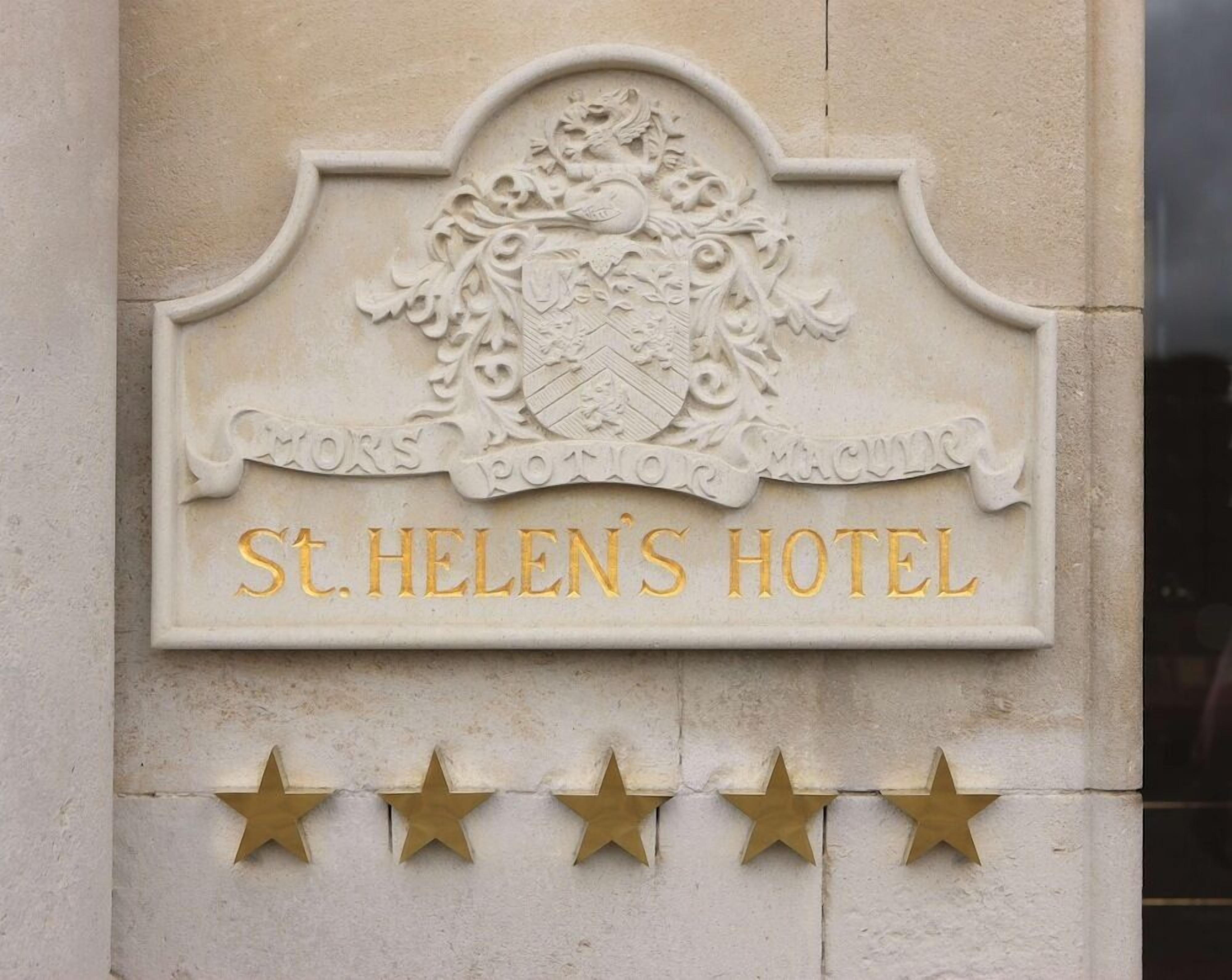 A hotel sign with a crest and the name 'St. Helen's Hotel' in gold lettering.