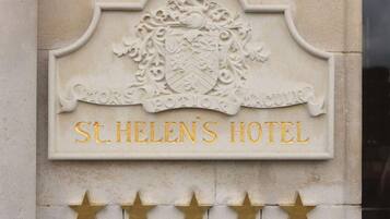 A hotel sign with a crest and the name 'St. Helen's Hotel' in gold lettering.