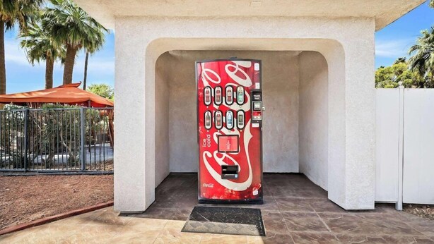 A Coca-Cola branded vending machine under a white archway. - Surestay Hotel By Best Western Blythe (Blythe)