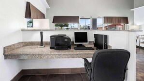 A modern hotel room with a desk, computer, printer, and a chair. - Surestay Hotel By Best Western Blythe (Blythe)