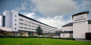 Un moderno edificio de hotel con un cartel que dice 'HOTEL GREEN ISLE HOTEL'.