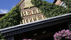 A building with a sign that reads 'BELL HOTEL' and ivy covering the walls. - The Bell In Driffield (Driffield)