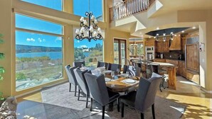 A spacious dining area with a large table, chairs, and a chandelier. - Big Bear Lakefront Luxury Home w/ Spa & Views (Big Bear Lake)