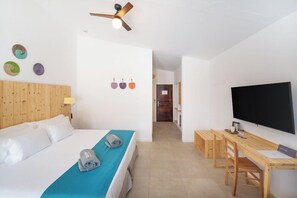 A hotel room with a bed, a desk, a television, and a ceiling fan. - Ahg Marine Club Beach Resort (Boa Vista)