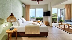 A bedroom with a bed, bedside table, lamp, and a view of the outdoors. - Vasia Sea Retreat - Adults Only (Agios Nikolaos)