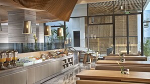 A modern restaurant with a long counter, wooden ceiling, and seating area. - CM+ Serviced Apartment Shenzhen Hillside (Shenzhen)