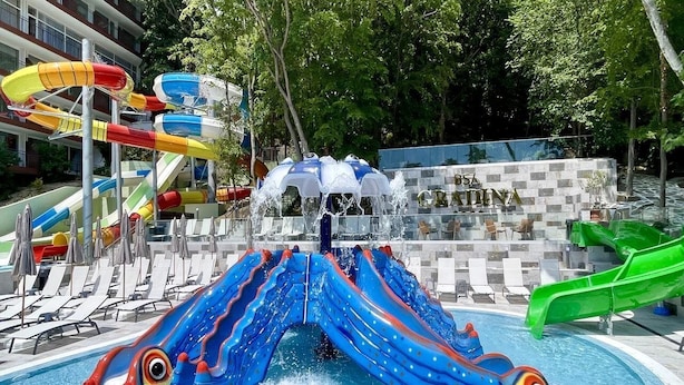 A pool area with multiple slides and umbrellas, a sign reading 'BSB CRADINA', and lounge chairs. - BSA Gradina Hotel & Aquapark (Varna)
