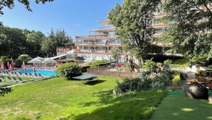 A hotel with a swimming pool, outdoor seating, and a playground. - BSA Gradina Hotel & Aquapark (Varna)