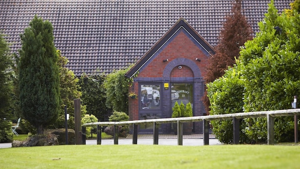 A brick building with a tiled roof, a sign indicating a restaurant, and a well-maintained lawn. - Campanile Washington Newcastle-upon-tyne (Washington)