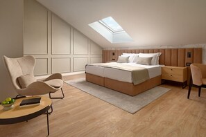 A bedroom with a skylight, a bed, a bedside table, a chair, and a small table with a bowl of fruit. - Hotel Moeesy Blue Green Oasis Ex Croatia Hotel Hvar (Hvar)