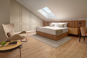 A bedroom with a skylight, a bed, a nightstand, a chair, and a small table with a bowl of fruit. - Hotel Moeesy Blue Green Oasis Ex Croatia Hotel Hvar (Hvar)