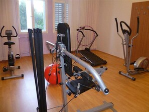 A gym with exercise equipment including a treadmill, elliptical, and stationary bike. - Hotel Moeesy Blue Green Oasis Ex Croatia Hotel Hvar (Hvar)