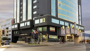 A modern hotel with a prominent casino sign, large windows, and a distinctive architectural design. - Kingdom Hotel Lima (Lima)