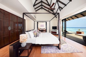 A bedroom with a bed, a TV, and a view of the ocean. - NH Collection Maldives Havodda Resort (Havodda)