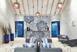 A modern living room with a sofa set, a coffee table, and decorative lamps. - NH Collection Maldives Havodda Resort (Havodda)