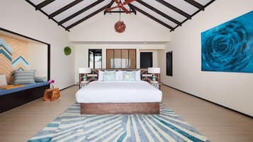 A modern bedroom with a large bed, a ceiling fan, and a blue abstract painting.