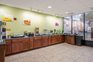 A cafe with a long counter, coffee machines, and a window view. - Best Western Premier Lakeland North (Lakeland)