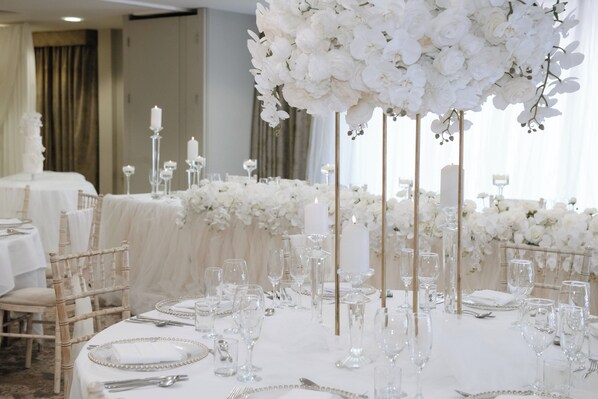 A banquet hall with round tables, white floral arrangements, and candle holders. - Clarion Hotel Newcastle South Boldon EN (Boldon Colliery)
