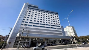 A multi-story hotel with a modern facade, large windows, and a covered entrance. - Hotel Gran Vivenzo Belo Horizonte (Belo Horizonte)