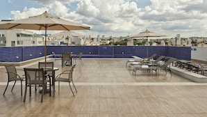 A rooftop terrace with outdoor seating and umbrellas, overlooking a cityscape. - Hotel Gran Vivenzo Belo Horizonte (Belo Horizonte)
