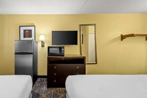 A hotel room with two beds, a refrigerator, a microwave, a dresser, a television, and a mirror. - Rodeway Inn Albuquerque NM (Albuquerque)