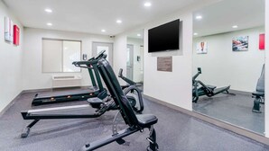 A gym with treadmills, a stationary bike, and a mirror. - Comfort Inn Antioch - Century Plaza (Antioch)