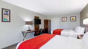 A hotel room with two beds, a desk with a chair, a TV, and a door. - Comfort Inn Antioch - Century Plaza (Antioch)