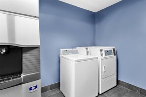 A laundry facility with a washing machine, dryer, and a water dispenser. - Quality Inn & Suites Wytheville (Wytheville)
