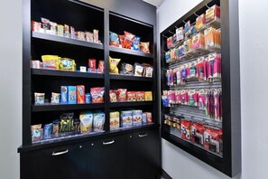 A snack and toiletry section with shelves stocked with various products. - Garden Plaza Hotel (Marietta)