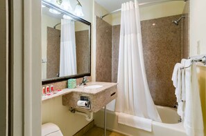 A bathroom with a shower, a sink, a toilet, and a mirror. - Fairbridge Inn Express Pittsfield MA (Pittsfield)