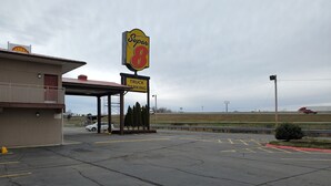 A parking lot with a Super 8 sign, a truck parking sign, and a Shell gas station in the background. - Super 8 Little Rock North Airport (North Little Rock)