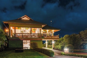 A two-story building with a balcony, large windows, and a well-lit entrance. - Hotel Ficus Monteverde (Monteverde)