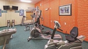 A gym with stationary bikes, a treadmill, and exercise equipment. - Houston Hobby Airport (Houston)