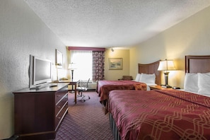 A hotel room with two beds, a desk with a TV, a chair, and a lamp. - Econo Lodge Inn and Suites Joplin MO (Joplin)