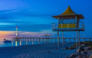 A pier extending into calm waters with a lookout tower and a small pavilion. - Mantra Adelaide Central (Adelaide)